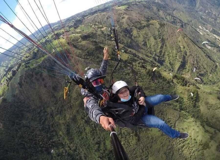Paragliding Medellin with Transportation and free Videos - Your 15-Minute Flight: GoPro Views and Air Tricks Over Medellín